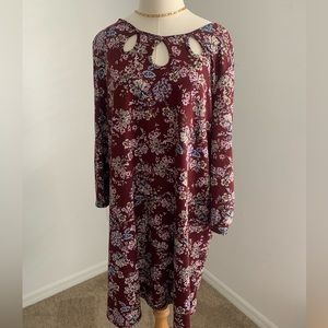 Floral maroon dress with peekaboo cut outs along the shoulder and collarbone.